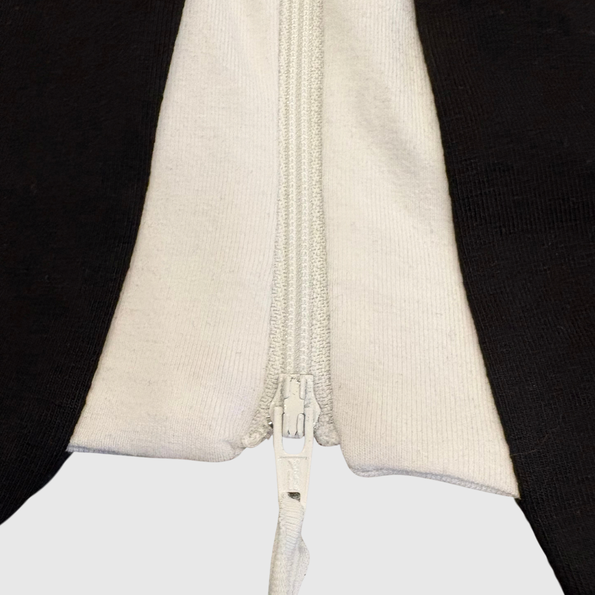 Close-up of the locking zipper slider on the sleeve
